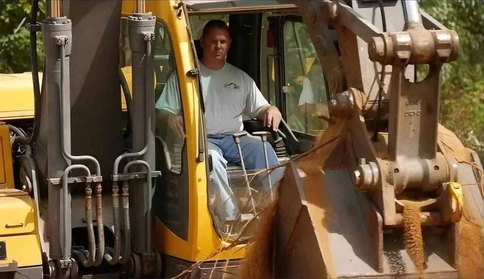 The owner-operator of Lodge Earthworks, Rob Lodge, operating a piece of heavy equipment.